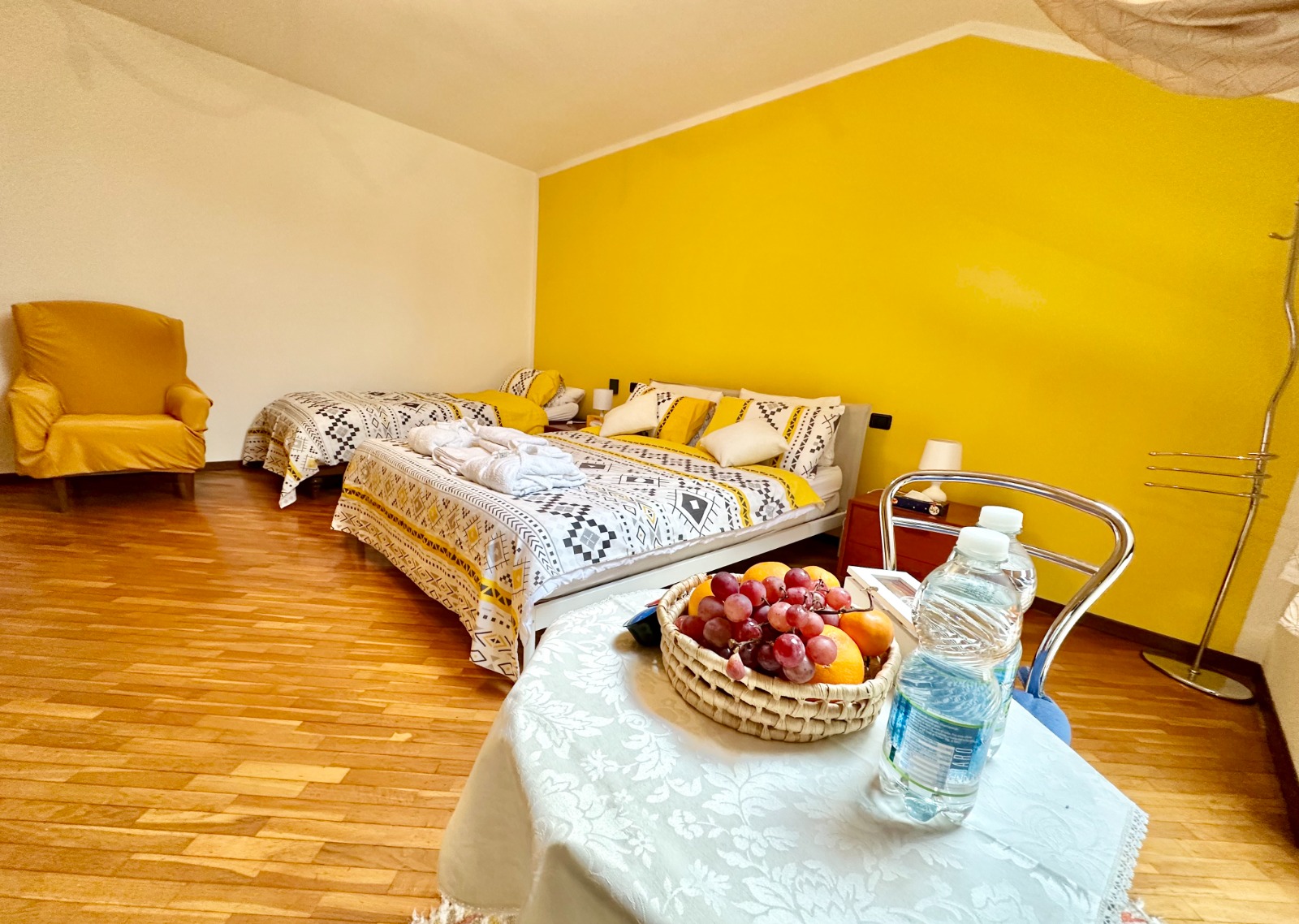 Elegant Italian bedroom with traditional wooden furniture and warm cream walls in Santa Margherita room